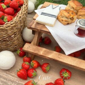 Spruce York afternoon tea picnic benches at an event with strawberries and scones