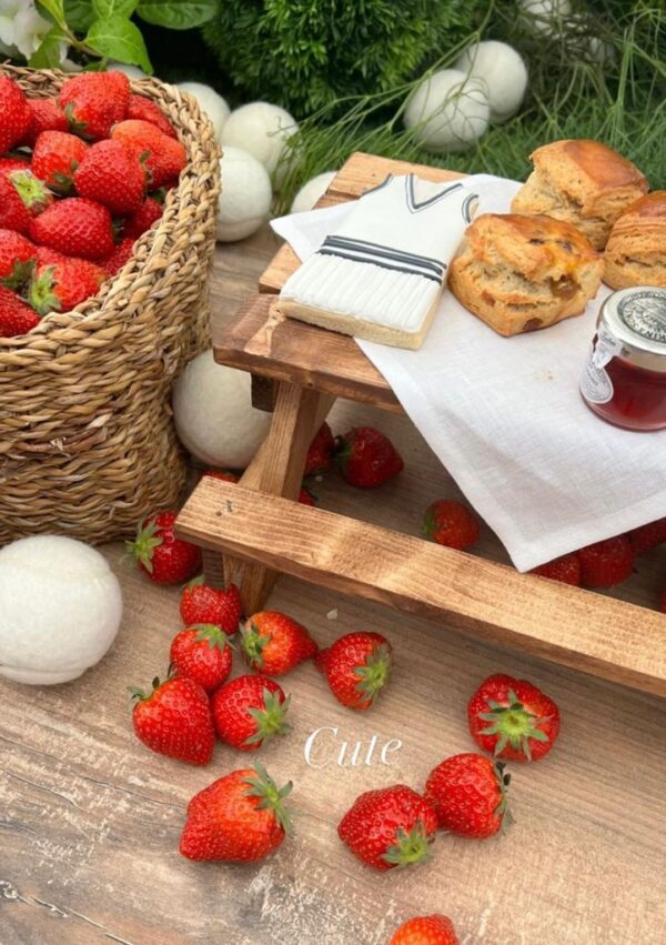 Spruce York afternoon tea picnic benches at an event with strawberries and scones